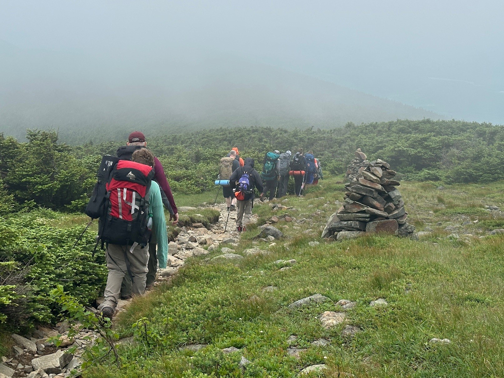 Scouts hiking by some rocks