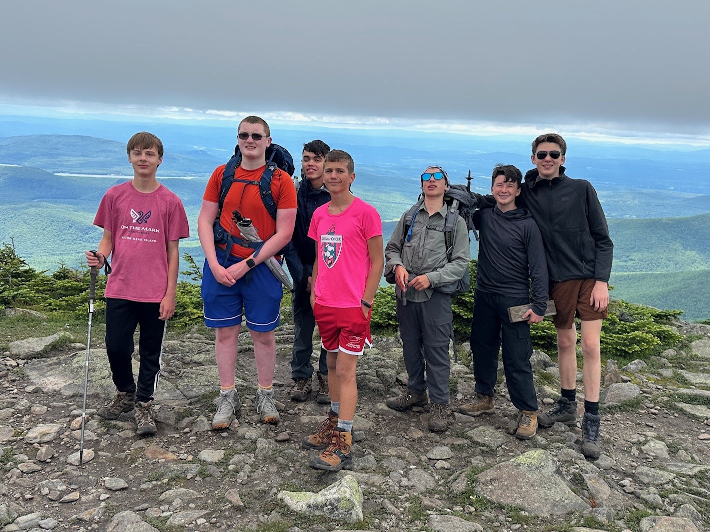 A handful of scouts posing for a picture near the summit