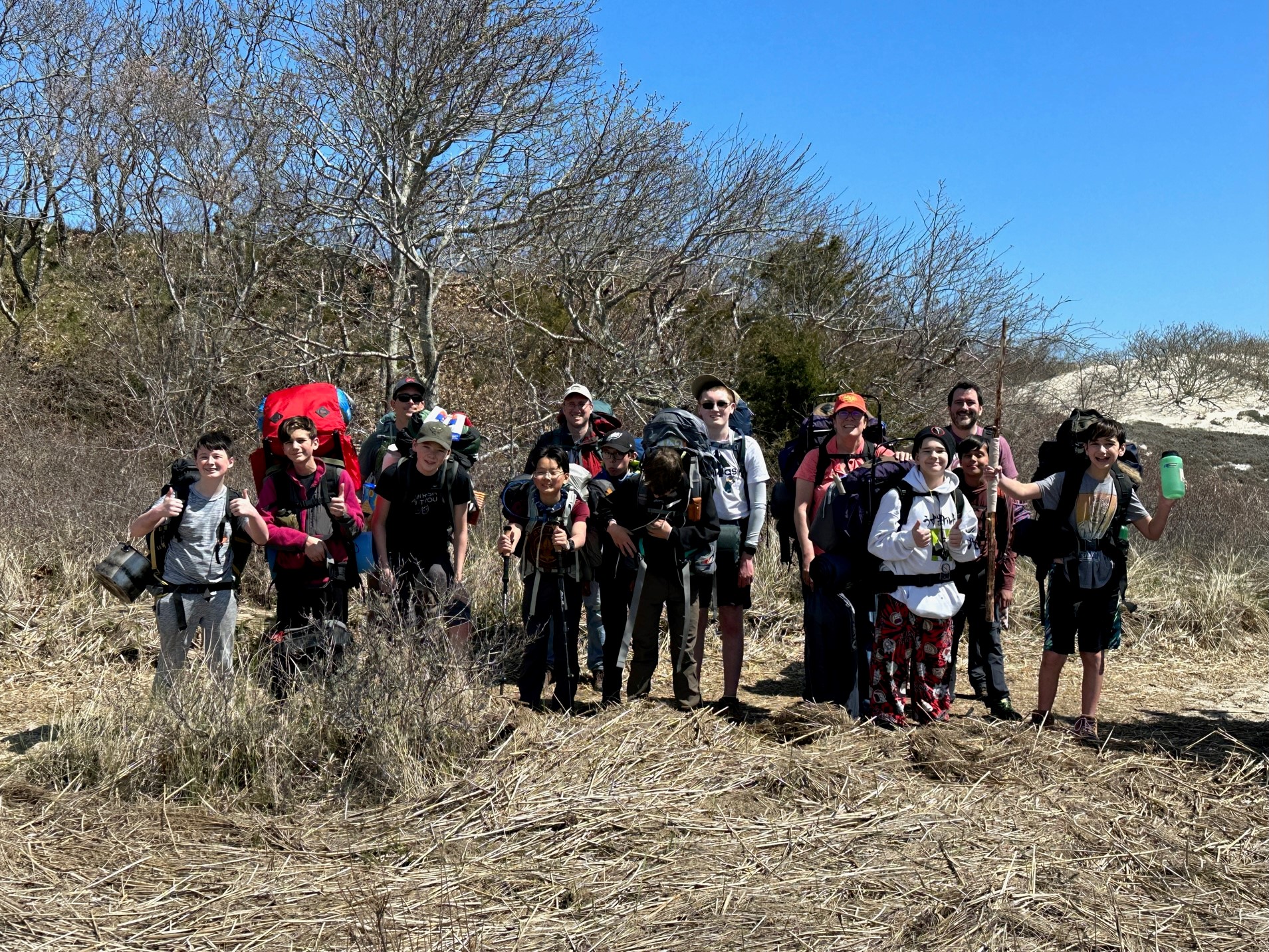 group in front of dunes