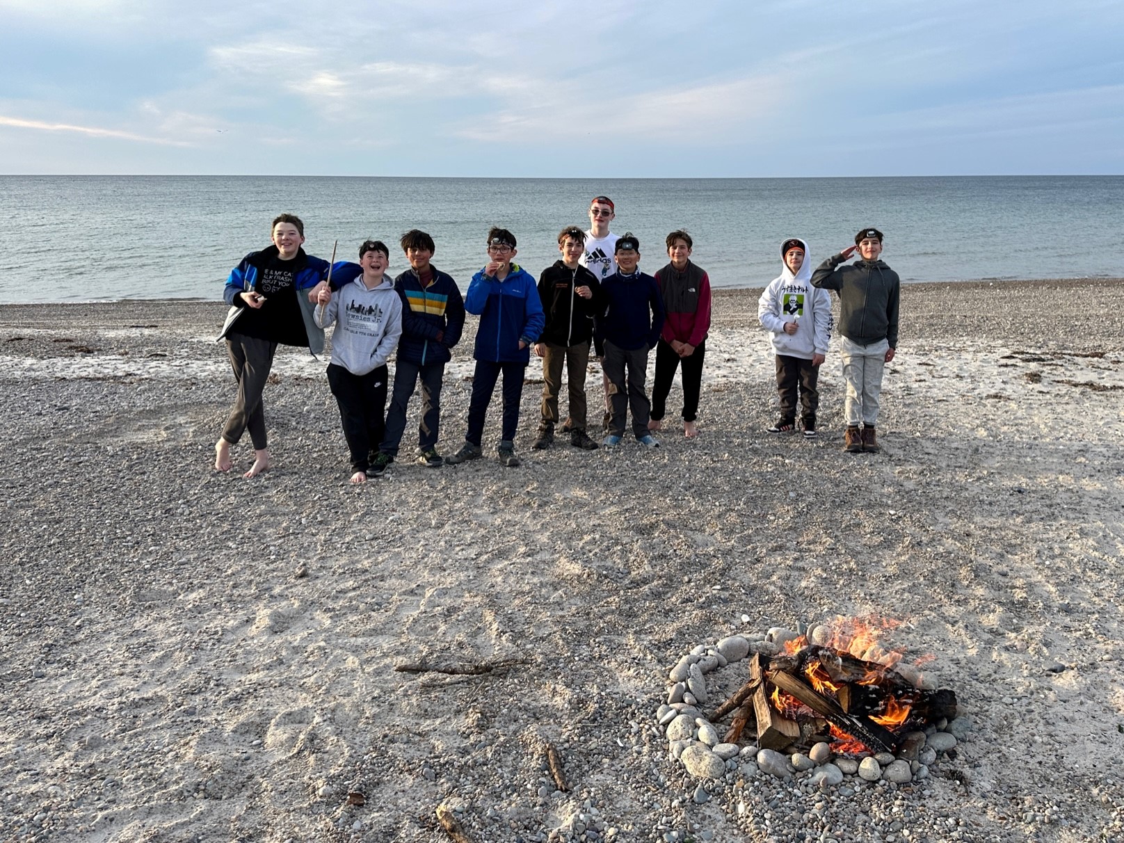 kids between campfire and ocean